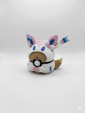 Plush toy resembling a character from a popular game on a white background, pokemon, sylveon, pokeball
