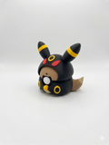 Black and yellow character with red accents on a white background