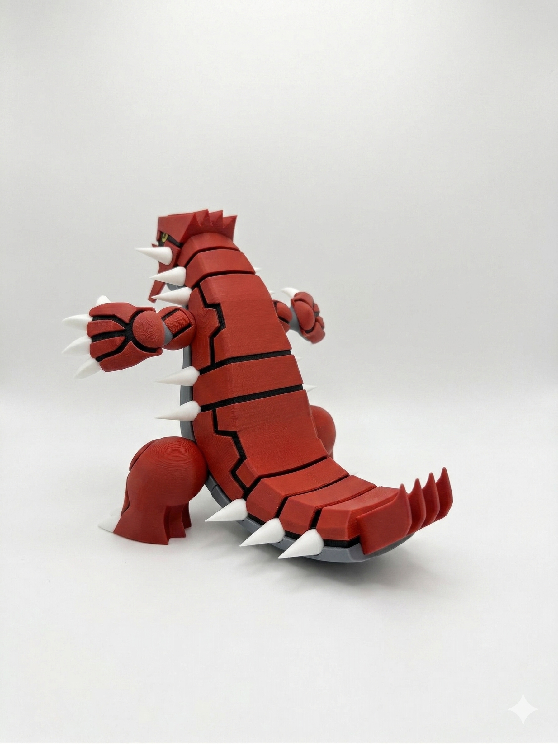 Red and gray monster-like figurine on a white background
